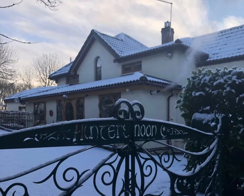 The wrought-iron gate in the snow